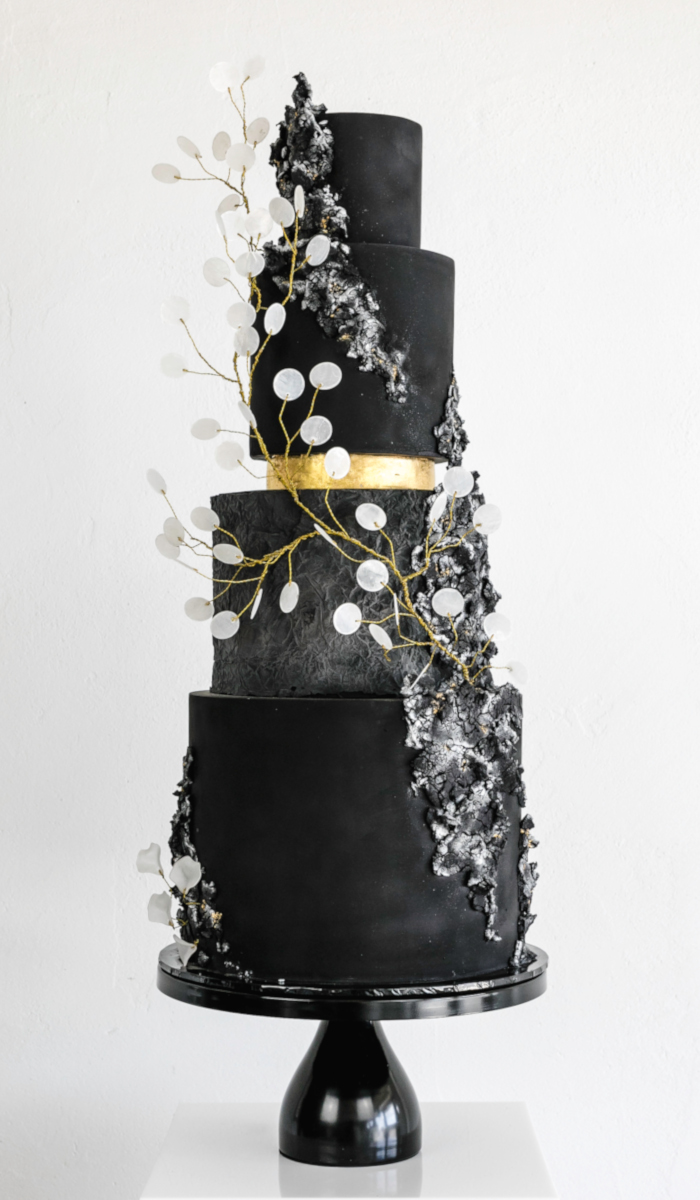 modern black wedding cake with gold foil